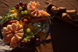 a bowl of fruit on top of a table at Wolwedans Dune Camp in NamibRand +20 photos