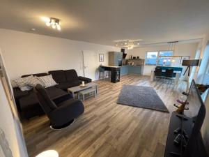 a living room with a couch and a table at Koje Seelöwe in Wangerland