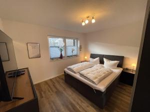 a bedroom with a bed and a window at Koje Seelöwe in Wangerland