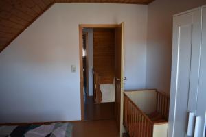 an attic room with a hallway leading to a bedroom at Nordlys in Hooksiel