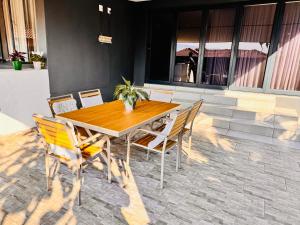 a wooden table and chairs on a patio at Bras boutique in Steelpoort
