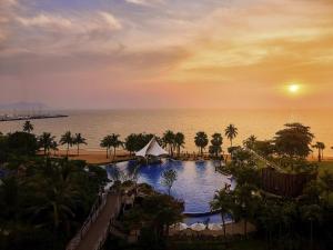 a view of a pool at a resort with the ocean at Mövenpick Siam Hotel Na Jomtien Pattaya in Na Jomtien