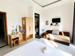 a hotel room with a bed and a tv at Thanh Nhã House in Da Lat +62 photos