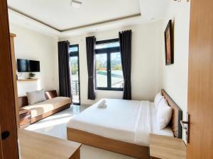 a hotel room with a bed and a couch at Thanh Nhã House in Da Lat