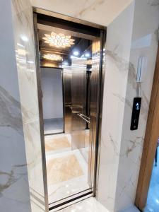 a shower with a glass door in a bathroom at Thanh Nhã House in Da Lat
