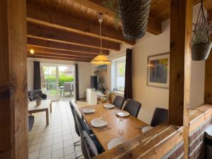 a dining room with a wooden table and chairs at Tegeler Plate 26 in Wangerland