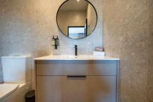 a bathroom with a sink and a mirror at The Circle Luxury Self Catering Studios in Potchefstroom +64 photos