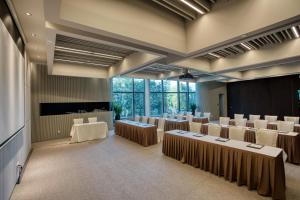 a conference room with tables and chairs and a stage at Shenzhen O Hotel in Shenzhen
