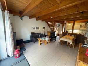 a living room with a couch and a table at Haus Tillmann mit Hund in Hooksiel in Wangerland