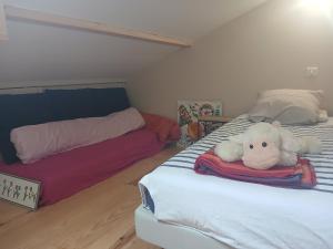 a bedroom with a bed with a stuffed animal on it at Bizi logela in Bidarray +4 photos