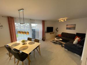 a living room with a table and a couch at Wangeroase in Wangerland