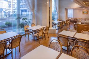 an empty restaurant with tables and chairs at Hotel New Green Plaza in Nagaoka