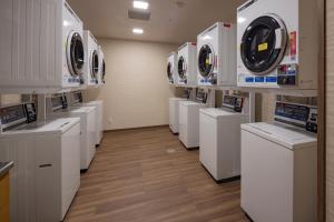 a laundry room with white washers and dryers at Hotel New Green Plaza in Nagaoka