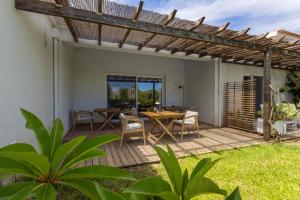 a patio with a table and chairs and a pergola at Abacatus Farmhouse in Tavira