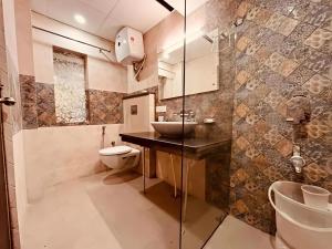 a bathroom with a sink and a toilet at The Pine Woods - A Four Star Luxury Resort In Mussoorie Near JW Marriott in Mussoorie +52 photos