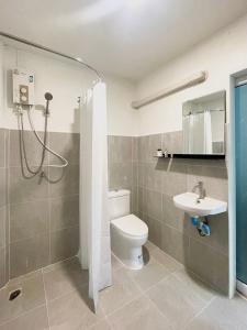 a bathroom with a toilet and a sink at Simple Cozy House Coconut Lane in Hinkong