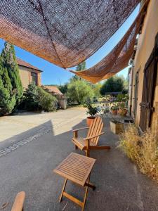 two chairs and a table on a patio at Chambre d'hôtes de l'Angeline in Bissey-sous-Cruchaud +6 photos