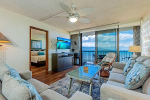 a living room with a couch and a table at Kanai A Nalu 318 in Wailuku