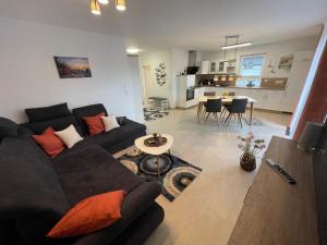 a living room with a black couch and a table at Wangeroase in Wangerland
