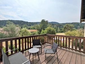 a deck with two chairs and a table and chairs on it at Chambre Jonquille in Rehaupal +6 photos