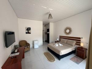 a bedroom with a bed and a flat screen tv at Tiptree Lodge in Livingstone +27 photos