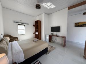 a bedroom with a bed and a tv in it at Tiptree Lodge in Livingstone