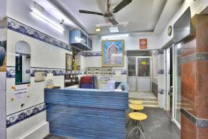 a restaurant with a blue and white counter and stools at SAMPATH RESIDENCY in Palni +59 photos