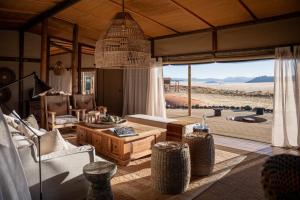 a living room with a view of the desert at Wolwedans Desert lodge in NamibRand