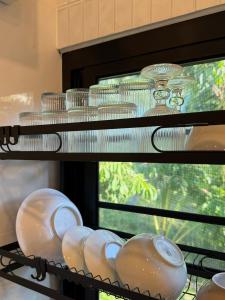 a shelf with plates and bowls on it at Moon & Banana in Ko Phangan