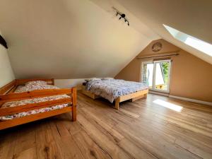 a bedroom with two beds and a window at Maison de vacances proche de Pontmain in Saint-Mars-sur-la-Futaie