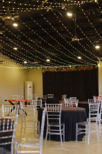 a banquet hall with white chairs and tables and lights at Velora The Luxury Resort in Māndu +66 photos