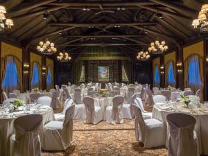 a banquet hall with white tables and chairs at Fairmont Le Chateau Montebello in Montebello +266 photos