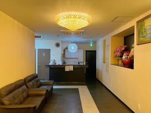 a living room with a couch and a bar at 大阪グランドホテル Osaka Grand Hotel in Osaka