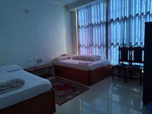 a bedroom with two beds and a window at Hotel Everest in Butwāl