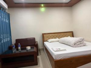a small bedroom with a bed and a chair at Hotel Everest in Butwāl