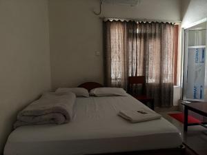 a bedroom with a large bed with towels on it at Hotel Everest in Butwāl