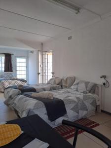 a room with three beds in a room at The haven in George