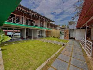 a large yard in front of a building at Omkar Beach Bungalow in Agonda