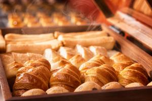 a tray of buns and pastries in a bakery at HOTEL MYSTAYS Nagoya Sakae -Renewed in September 2026 All Guest Rooms & Breakfast in Nagoya +50 photos