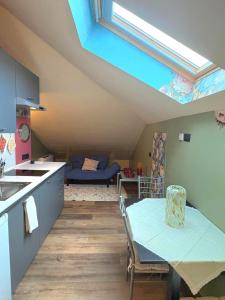 a kitchen with a table and a dining room at Il Nido Colorato in Settimo Torinese