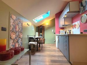 a kitchen with a table and chairs and a counter at Il Nido Colorato in Settimo Torinese +12 photos