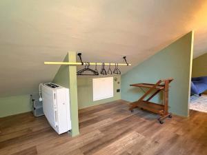 an attic room with a desk and a table in it at Il Nido Colorato in Settimo Torinese