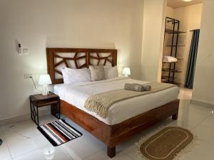 a bedroom with a large bed and two night stands at Tiptree Lodge in Livingstone