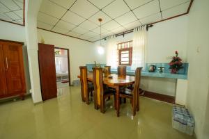 a dining room with a wooden table and chairs at Ocean villa in Hiriketiya