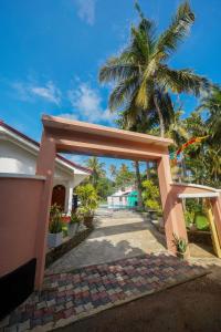 a doorway to a house with a palm tree at Ocean villa in Hiriketiya