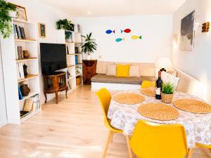 a living room with a table and yellow chairs at Volcán de sal in Teguise