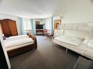a bedroom with three bunk beds and a desk at Hotel Adler - Weil am Rhein in Weil am Rhein