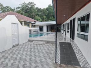 an external view of a house with a swimming pool at Chalet Gunung Stong in Dabung