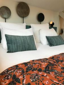 a bedroom with two beds with white pillows at Les Arbres Rouges in Sucé