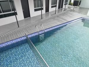 a swimming pool with blue water in a building at Chalet Gunung Stong in Dabung